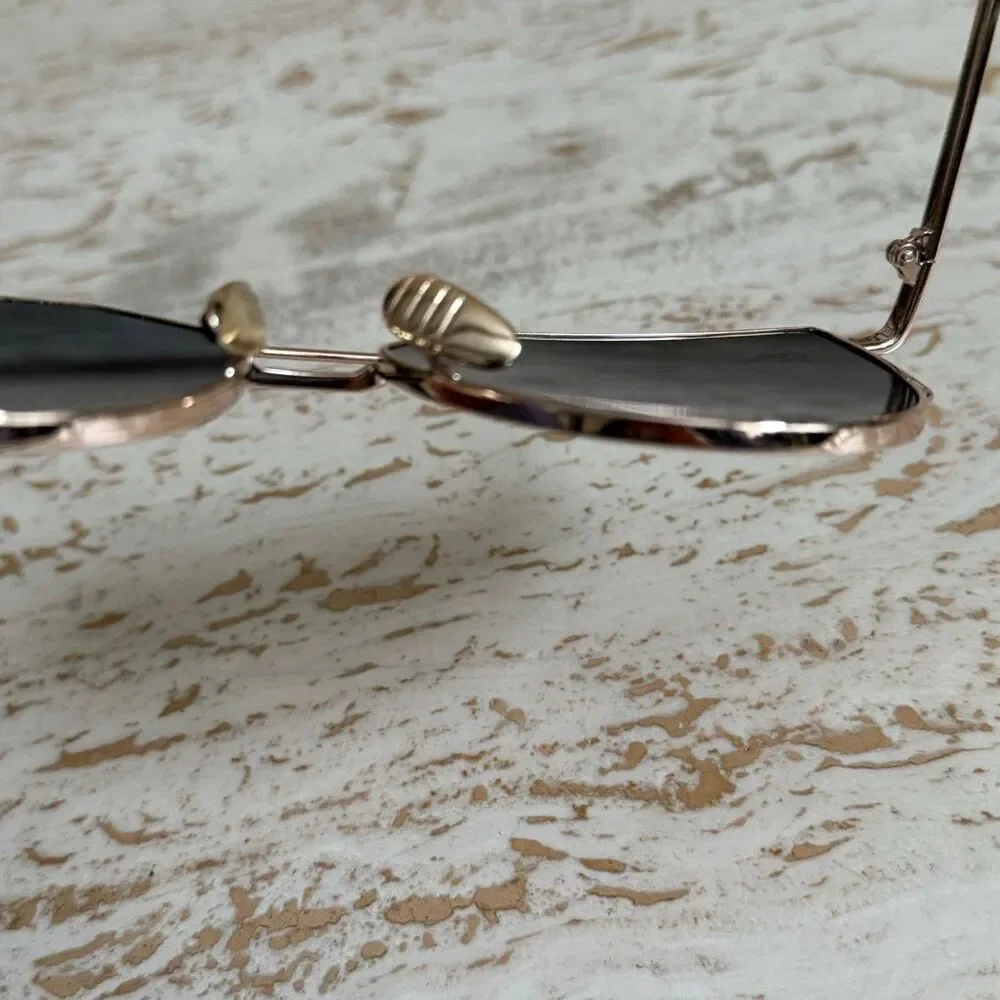 Rose gold wire frame cat eye aviator sunglasses with reflective pink lenses.